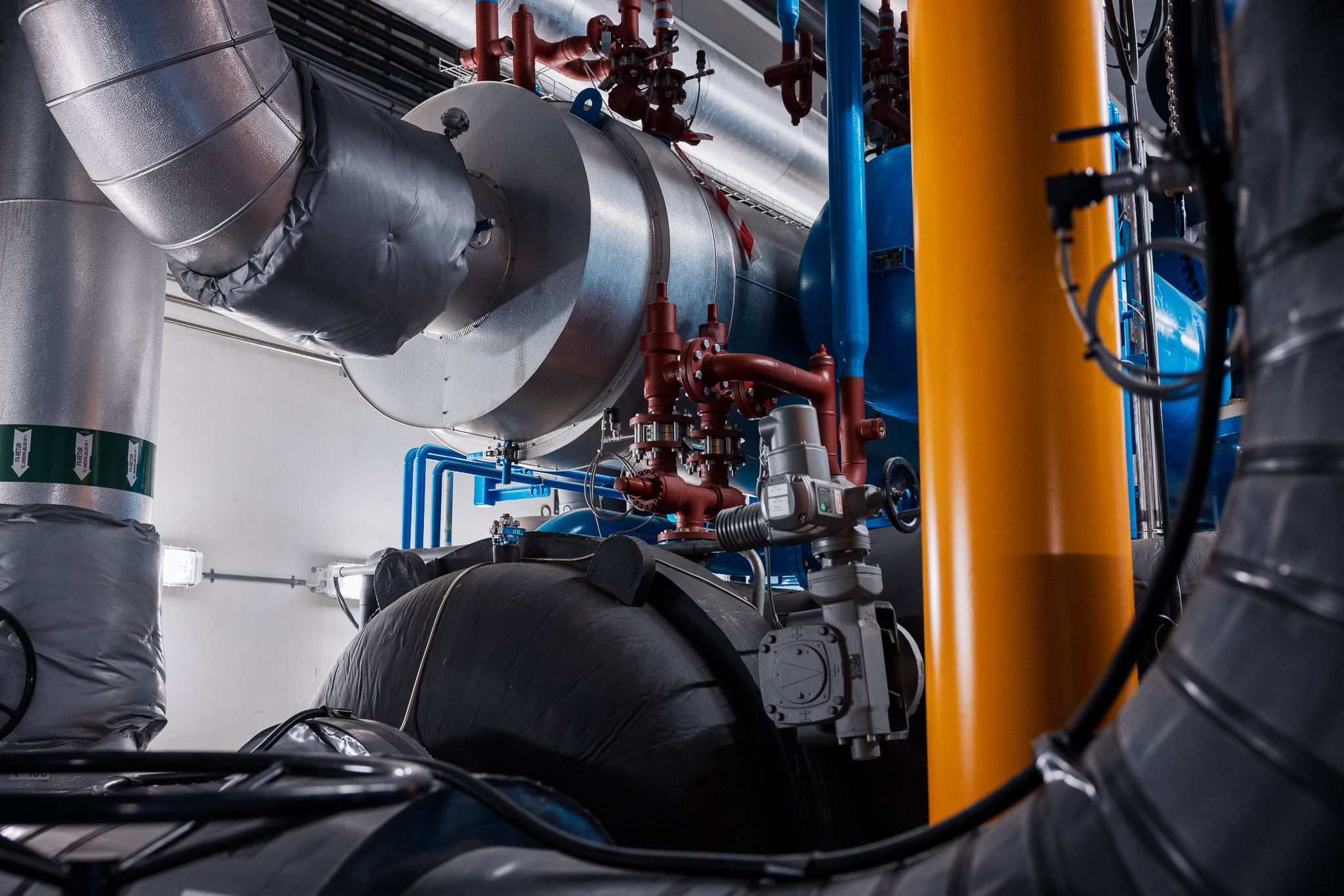 Anlegg for fjernvarme, med rør og maskineri.